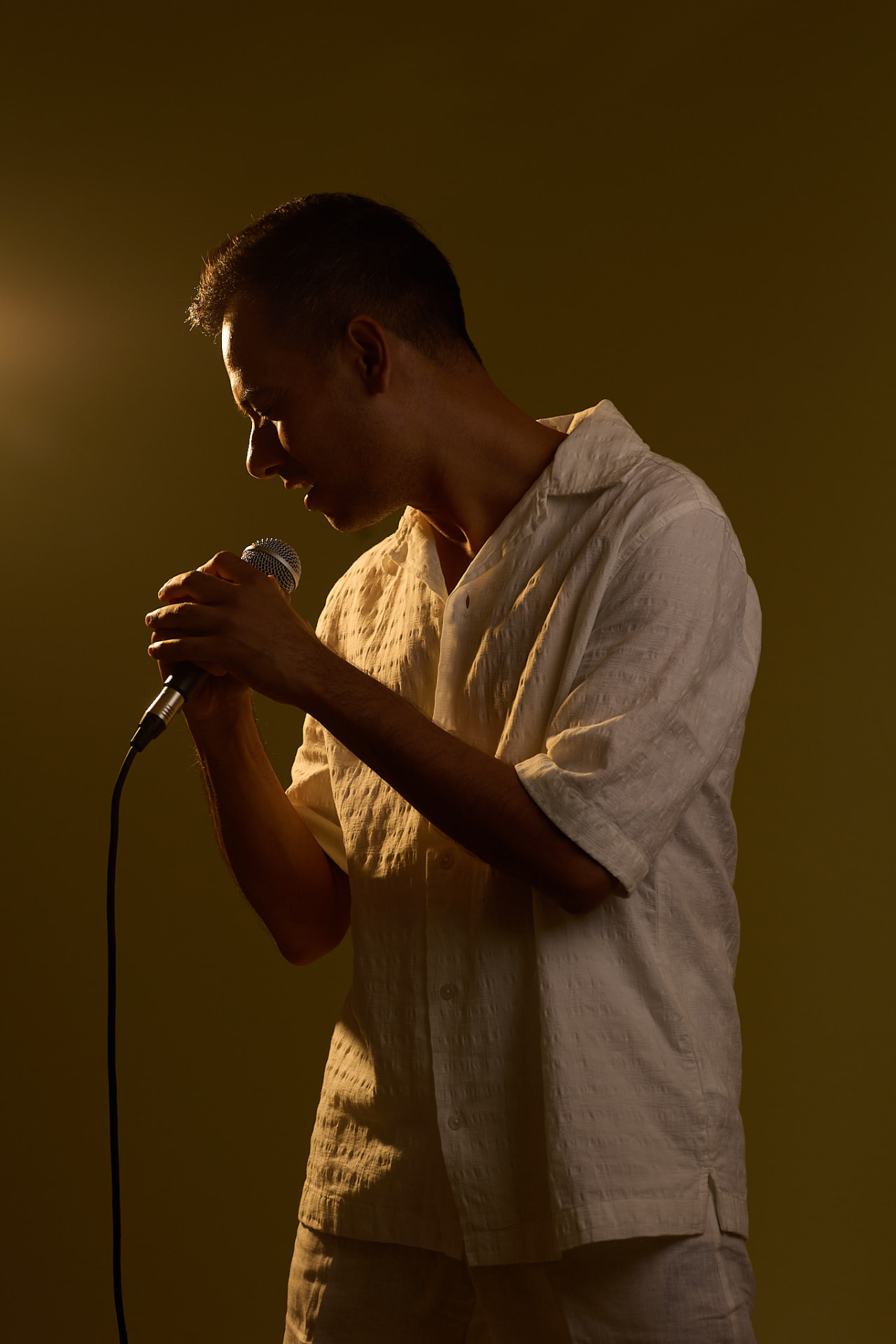 RJSoulflow singing into a handheld microphone